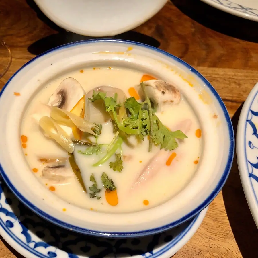 Kom romige Thaise soep met champignons en kruiden